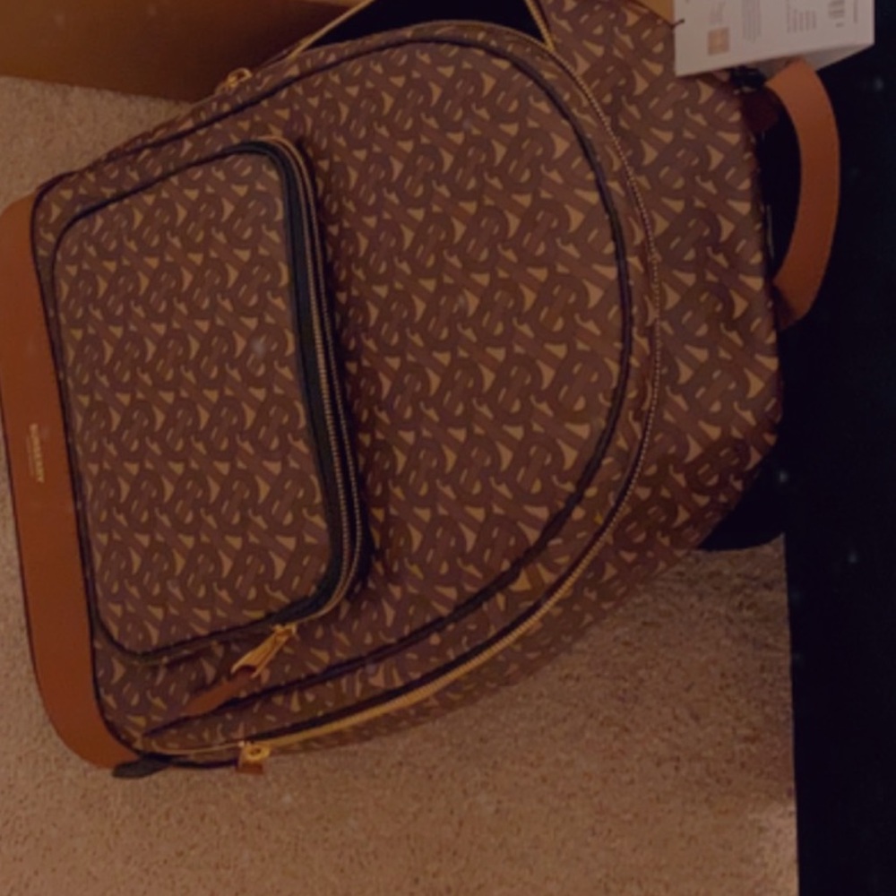 used Burberry bag with slight discoloration on small pocket and broken strap